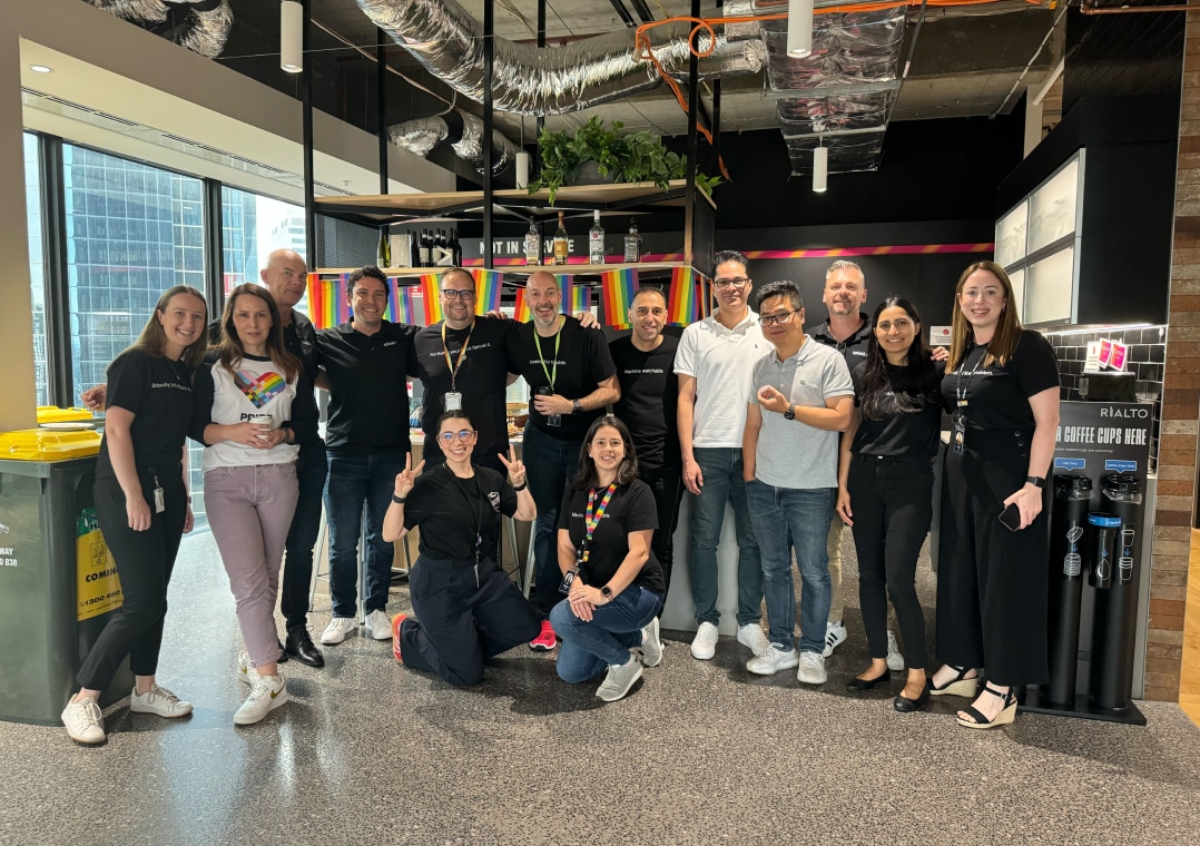14 Splunk employees pose together at a Pride Month party in the Melbourne office.